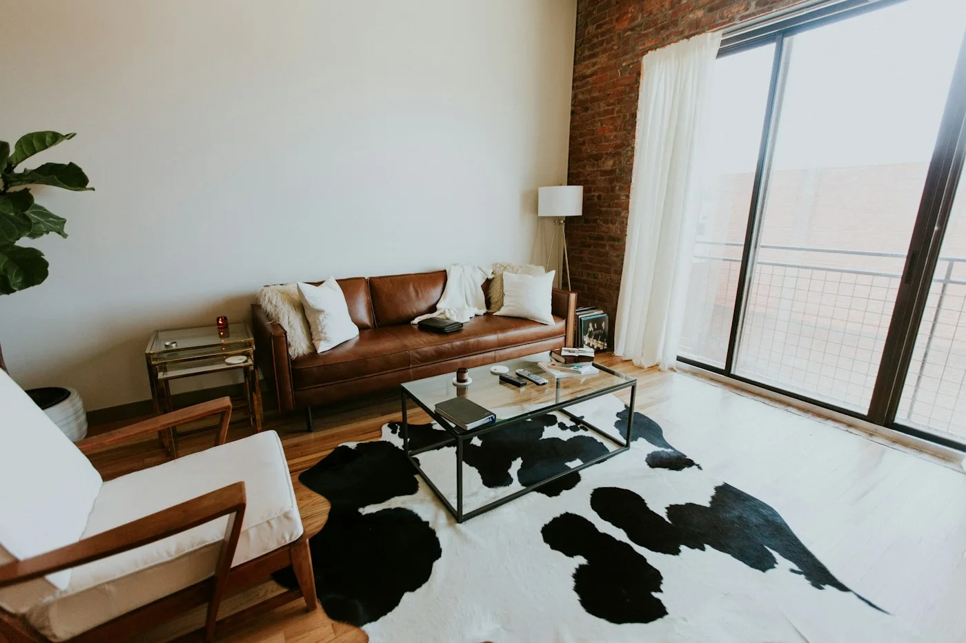 Living room with a sofa, furniture, and plants